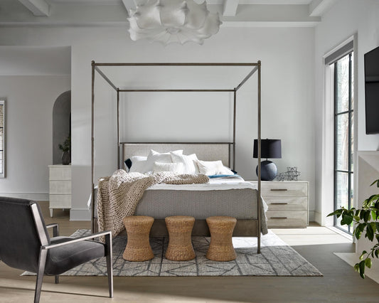 A chunky throw and decorative pillows on a bed