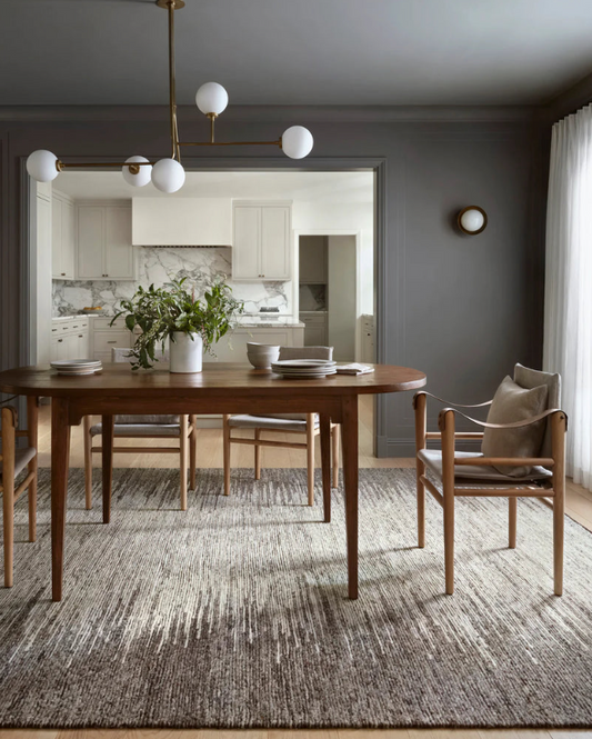 A beautifully decorated dining room set and rug