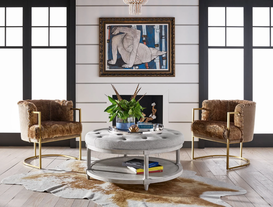 A gray ottoman in a beautifully decorated sitting area