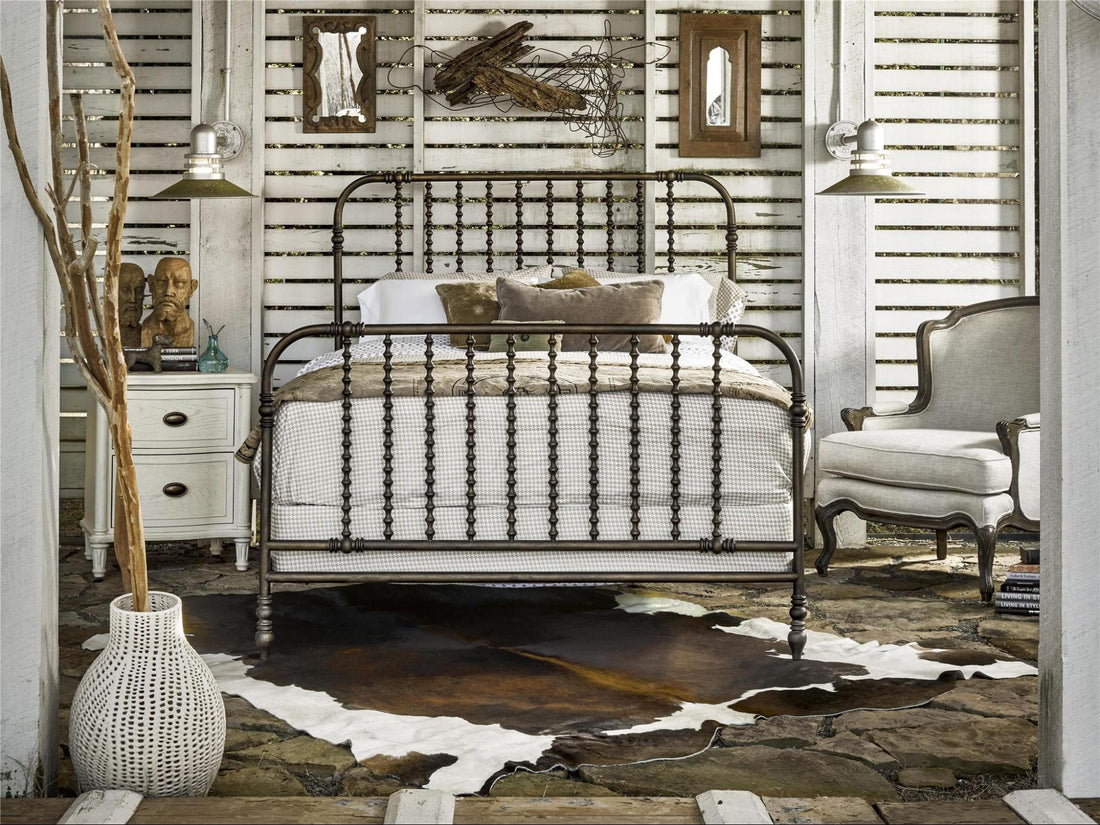 A tastefully designed bedroom set, with a bed frame, chair, and rug