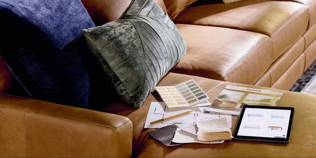 A tablet and color samples on a brown leather couch