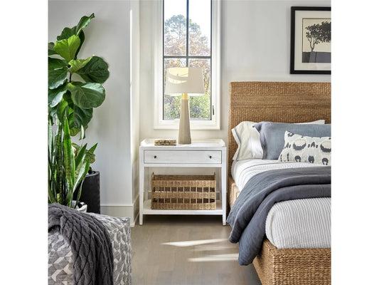 A Fiddle Fig plant, white nightstand, and bed