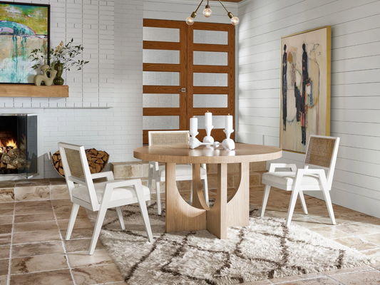 A wooden table and two white and brown dining room table chairs