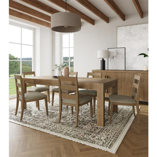 Six wooden chairs at a dining room table, with tasteful decor on the walls