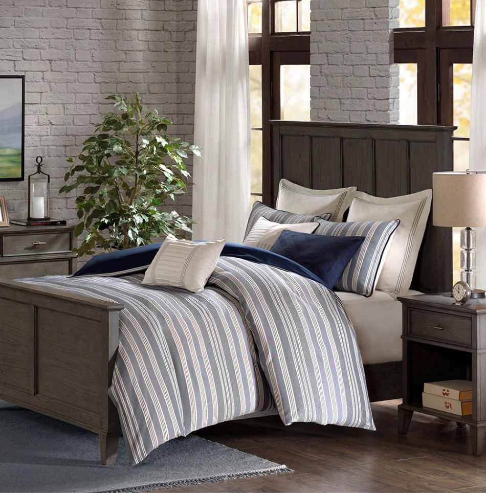 A dark wood bedroom set and striped duvet