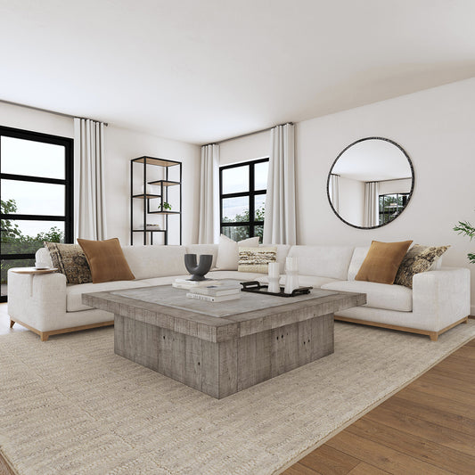 A luxury living room with a white sectional and a light gray coffee table 
