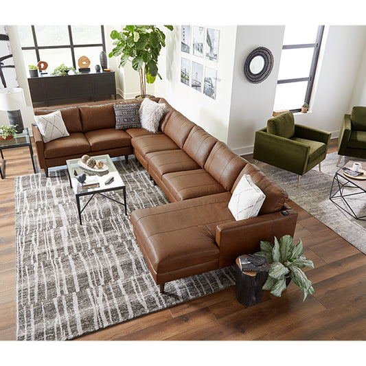 A brown leather sectional in the living room