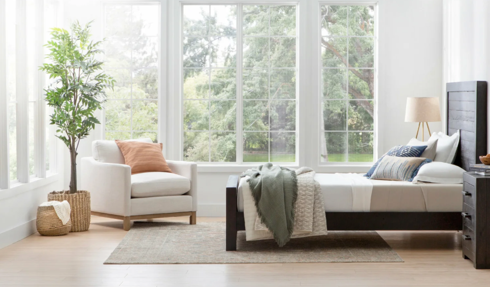  A darker wood bedroom set and nightstand and a lighter colored brown wood chair