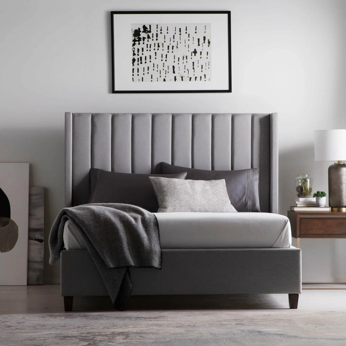 A gray bedroom set with wonderful lighting and wall art