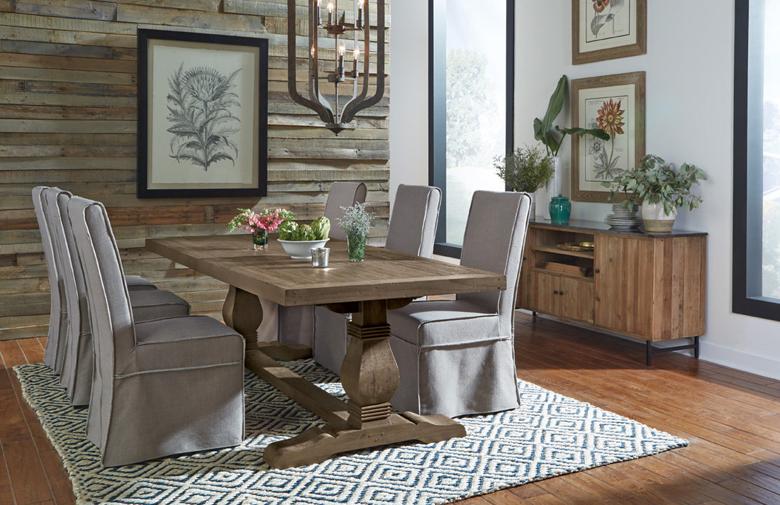 A six-person dining room table, with a patterned rug placed underneath 
