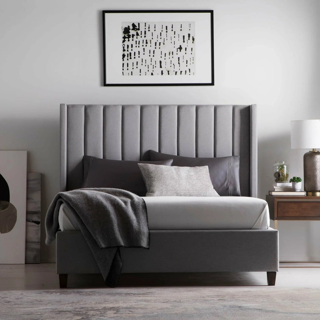 A gray bedroom set with wonderful lighting and wall art