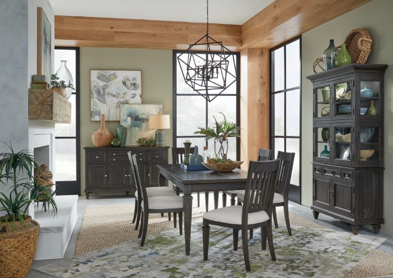 A brown dining room table, chairs, and buffet, complete with buffet decor 
