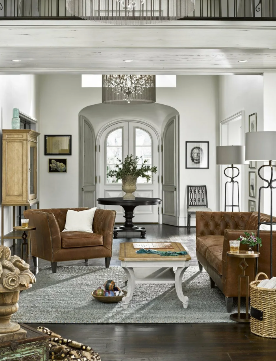 A brown loveseat and brown leather chair 