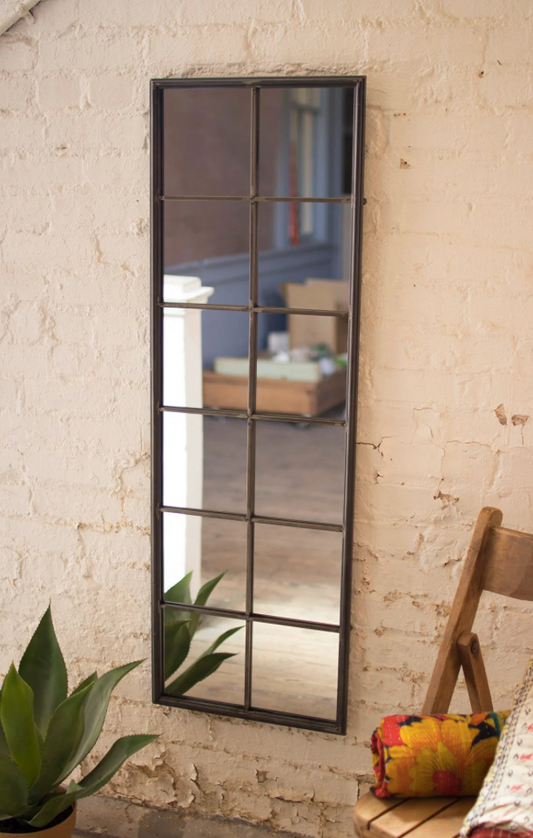 A mirror placed on a textured bedroom wall 